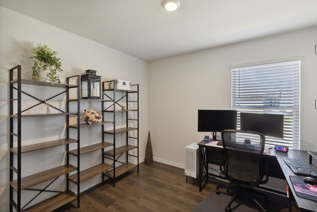 home office with dark hardwood / wood-style floors