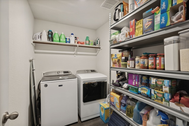 clothes washing area featuring washer and clothes dryer