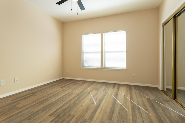 5616 Preston Oaks Rd Unit 1403, Dallas, TX 75254 - unfurnished bedroom featuring a closet, wood finished floors, and baseboards