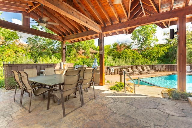 view of patio with ceiling fan and a community pool