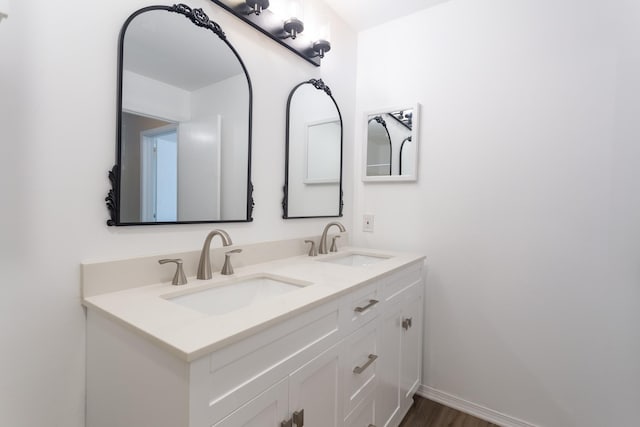 5616 Preston Oaks Rd Unit 1403, Dallas, TX 75254 - bathroom with double vanity, wood finished floors, and baseboards