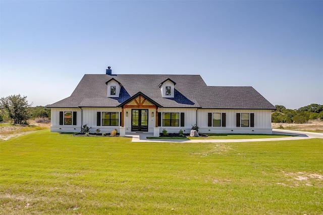 view of front of house with french doors and a front yard