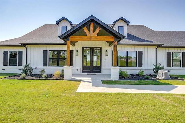 view of front of home featuring french doors and a front yard