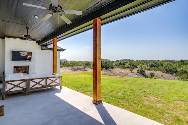 view of patio / terrace featuring ceiling fan and an outdoor brick fireplace