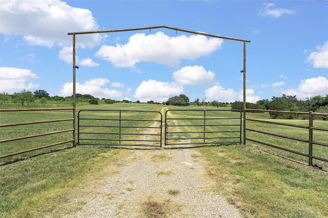 view of gate with a rural view