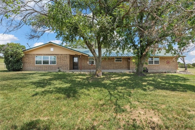 rear view of house featuring a lawn