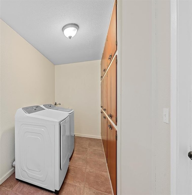 laundry room with light tile patterned flooring, a textured ceiling, and independent washer and dryer