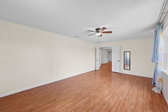 spare room with light hardwood / wood-style floors and ceiling fan