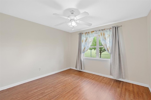 spare room with hardwood / wood-style flooring and ceiling fan