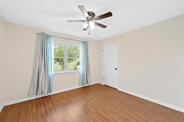 empty room with ceiling fan and hardwood / wood-style flooring