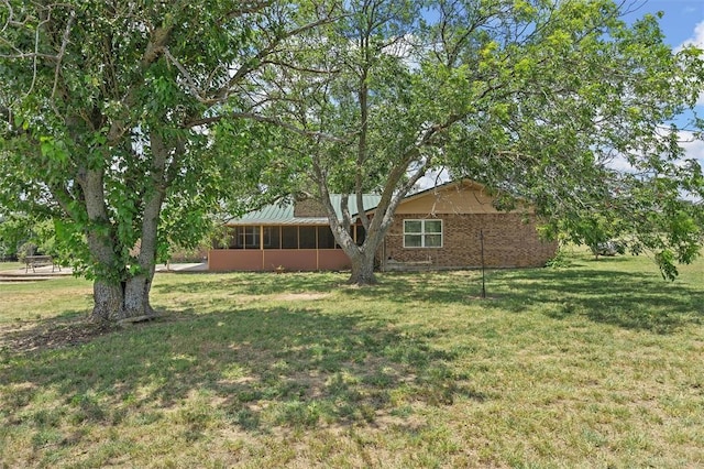 view of yard featuring a sunroom