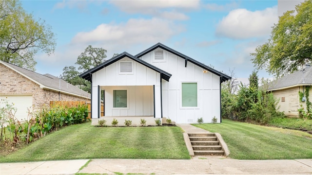 modern farmhouse style home with a front yard