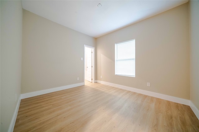 empty room with light hardwood / wood-style flooring