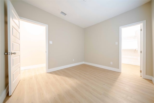 spare room with light hardwood / wood-style floors