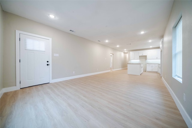 unfurnished living room featuring light wood-type flooring