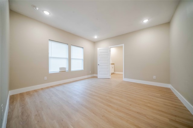 spare room featuring light hardwood / wood-style floors