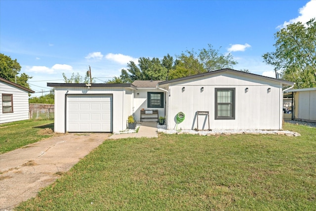 view of front of property with a garage and a front lawn