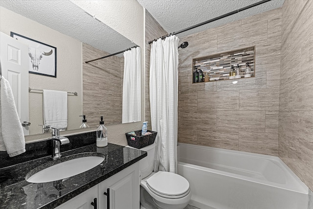 full bathroom with vanity, toilet, shower / bath combo with shower curtain, and a textured ceiling