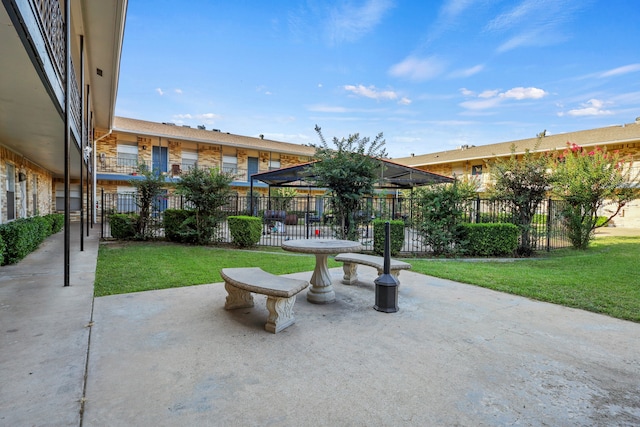 view of community with a patio and a yard