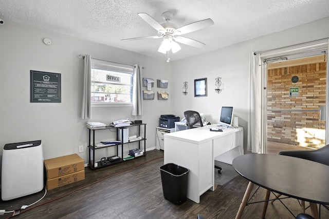 office area with a textured ceiling, ceiling fan, and dark hardwood / wood-style flooring