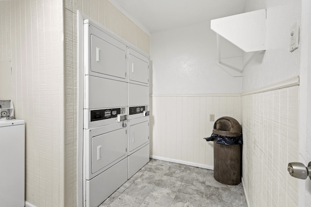 laundry room with stacked washing maching and dryer