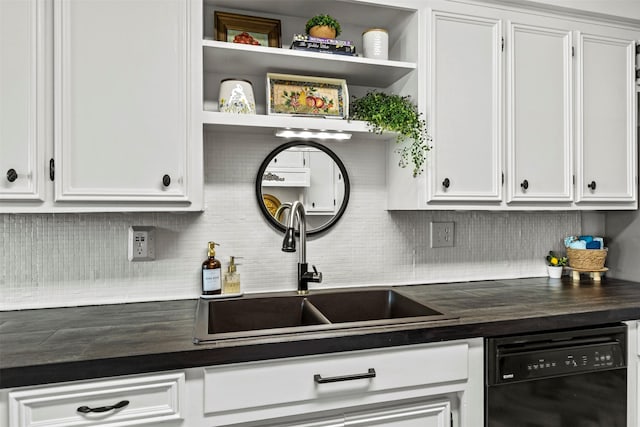 kitchen with decorative backsplash, white cabinetry, dishwasher, and sink