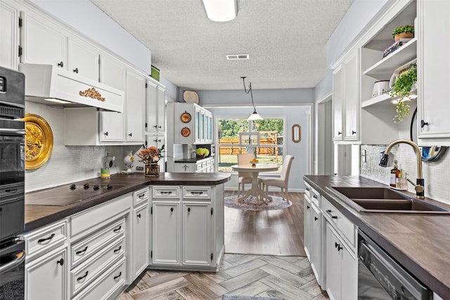 kitchen with white cabinets, wooden counters, black appliances, and sink