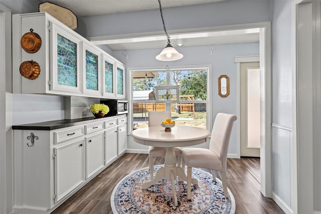 dining room with dark hardwood / wood-style flooring