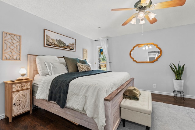 bedroom with a textured ceiling, dark hardwood / wood-style flooring, and ceiling fan