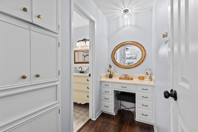 bathroom featuring vanity, wood-type flooring, and a textured ceiling