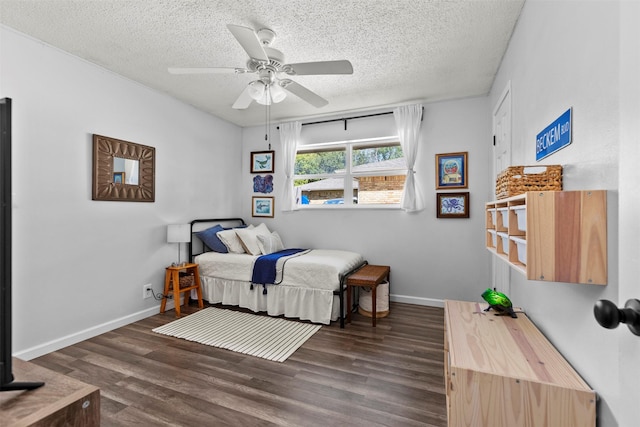 bedroom with dark hardwood / wood-style flooring, a textured ceiling, and ceiling fan