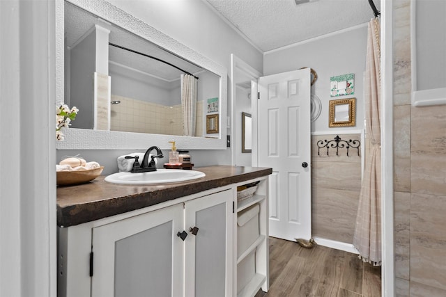 bathroom featuring vanity, hardwood / wood-style floors, and a textured ceiling