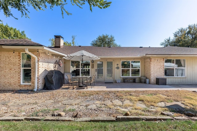 back of property with a patio