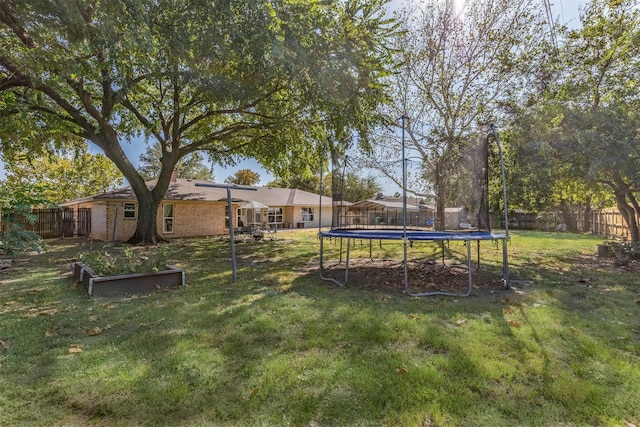 view of yard with a trampoline