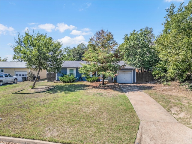 view of front of home featuring a garage and a front lawn