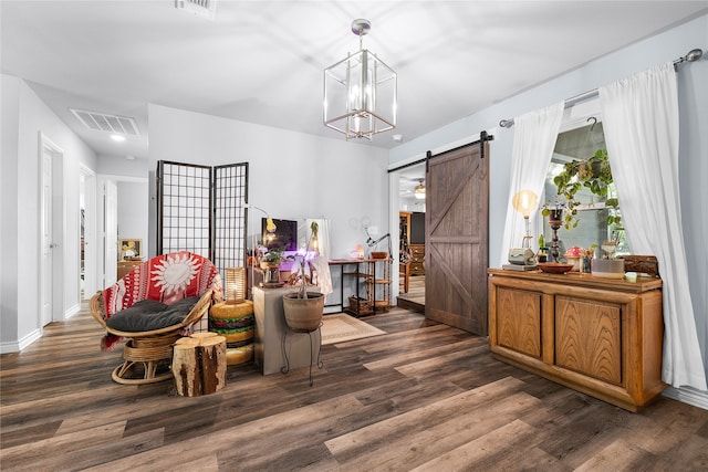 living area with a barn door, an inviting chandelier, and dark wood-type flooring