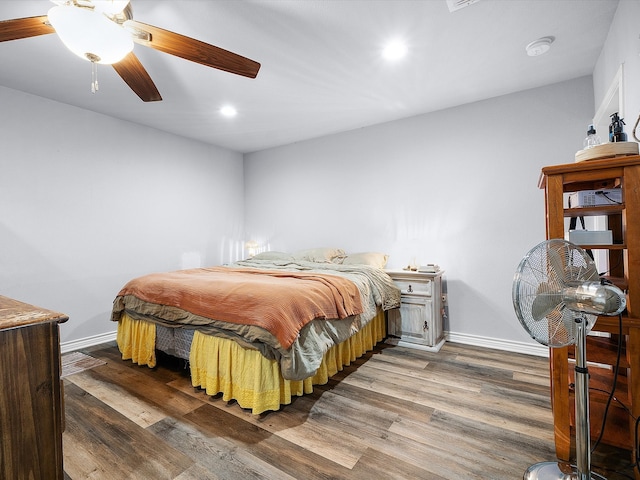 bedroom featuring ceiling fan and dark hardwood / wood-style floors