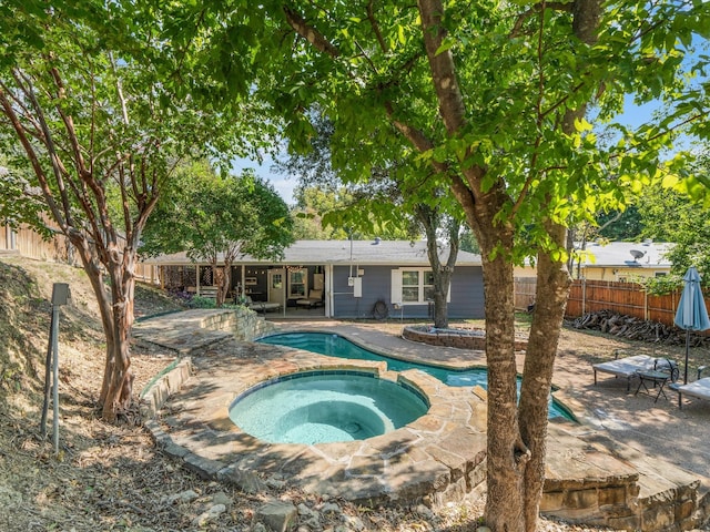 view of swimming pool with an in ground hot tub and a patio