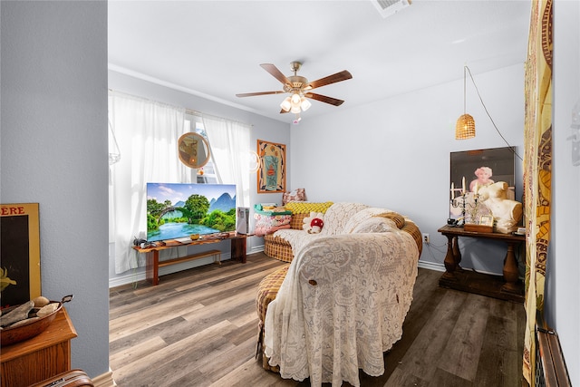 living room featuring wood-type flooring and ceiling fan