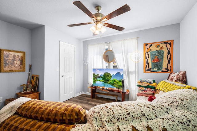 interior space with ceiling fan and dark hardwood / wood-style flooring