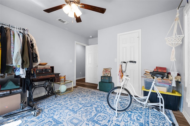 misc room with wood-type flooring and ceiling fan