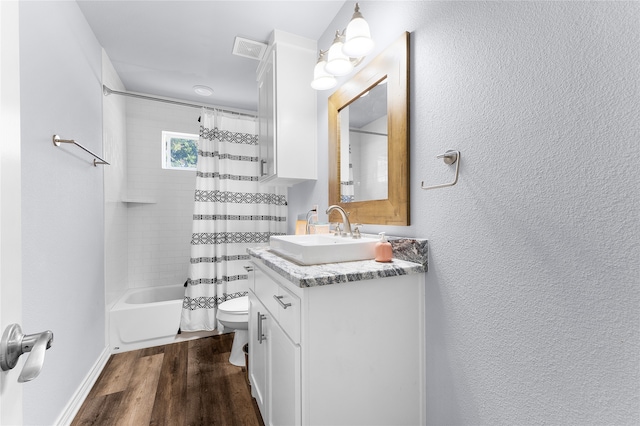 full bathroom featuring hardwood / wood-style floors, vanity, toilet, and shower / bath combo with shower curtain