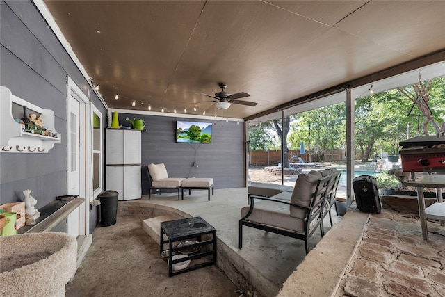 view of patio featuring a fenced in pool, ceiling fan, and a trampoline