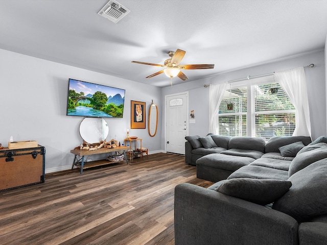 living room with ceiling fan and dark hardwood / wood-style floors