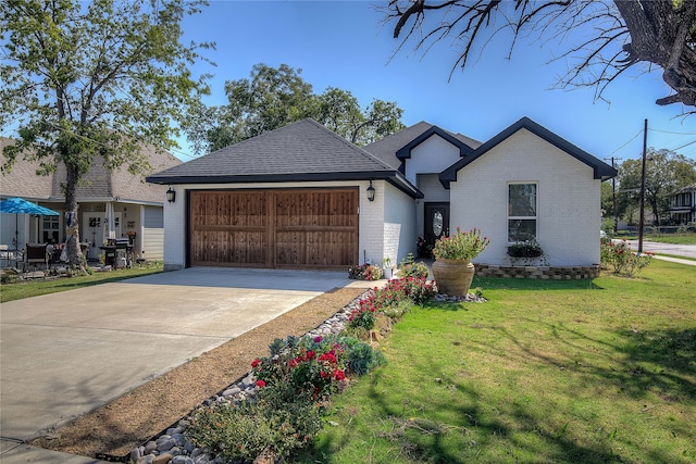 view of front of home featuring a garage and a front yard