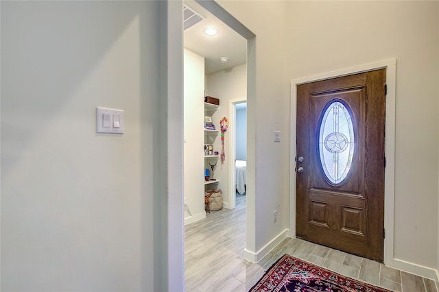 entryway with light hardwood / wood-style floors