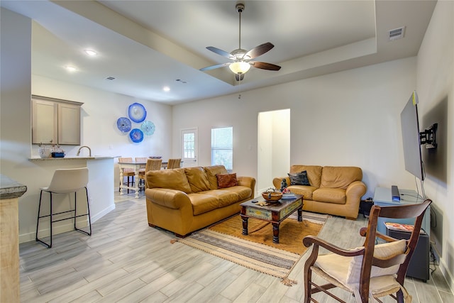 living room featuring ceiling fan and light hardwood / wood-style floors