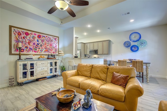 living room with ceiling fan and light wood-type flooring