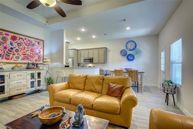 living room with ceiling fan and light hardwood / wood-style floors