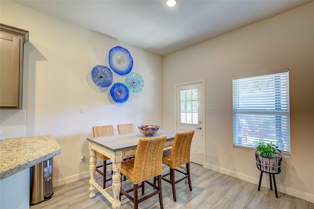 dining space with light wood-type flooring